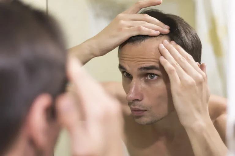 Close of of a man checking hairline