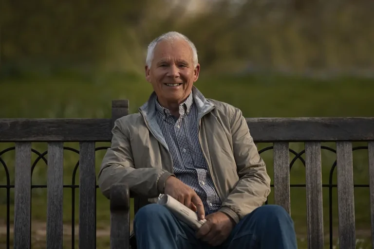 Front view of old man sitting on bench