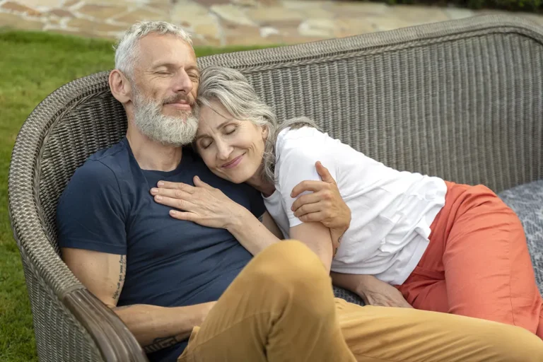 Smiling senior couple sitting on a bench