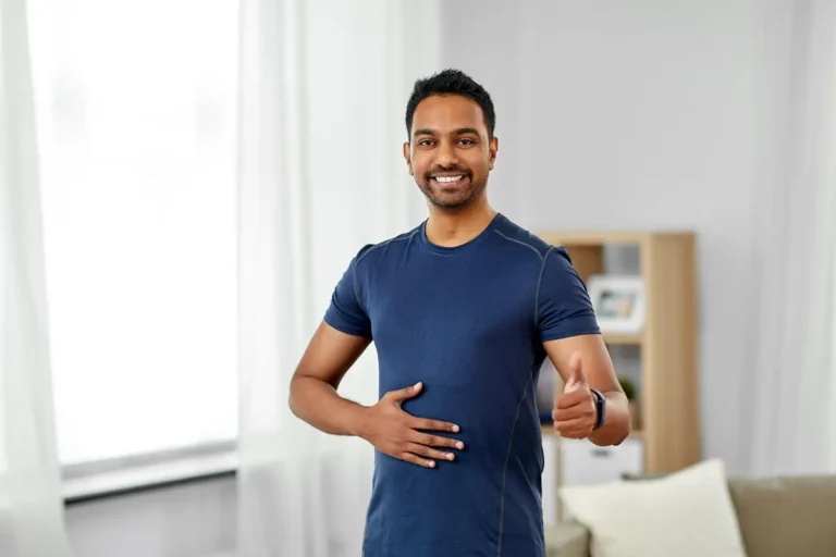 Indian man with fitness tracker showing thumbs up