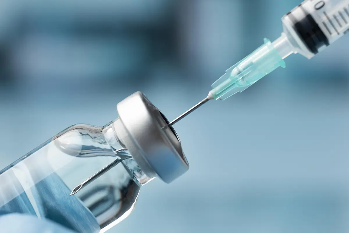 Extracting medicine from vial with injection needle
