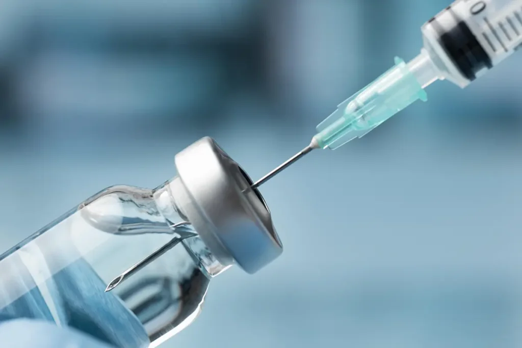 Extracting medicine from vial with injection needle