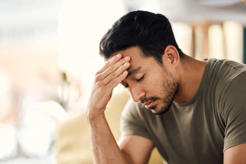 Man touching his forehead