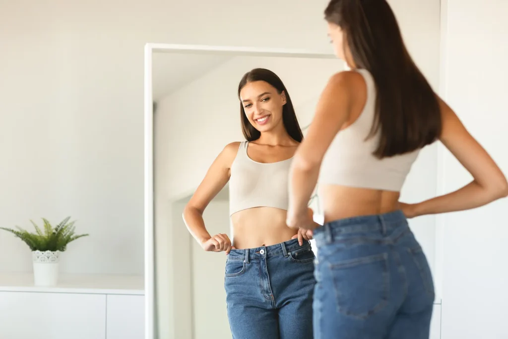 Smiling woman looking in the mirror