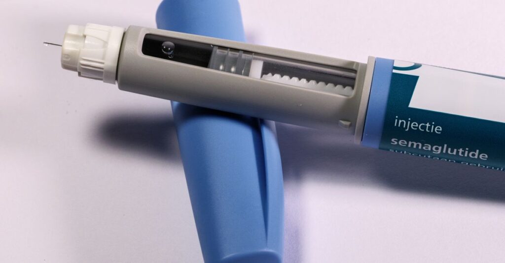 Detailed view of a semaglutide injection pen, commonly used for diabetes treatment, on a plain background. — compounded semag